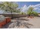 Paver patio with a built-in BBQ and firepit in a desert landscaped backyard at 1197 W Fir Tree Rd, Queen Creek, AZ 85140