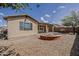 Large backyard with a built-in BBQ, firepit, and low-maintenance desert landscaping at 1197 W Fir Tree Rd, Queen Creek, AZ 85140