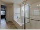 Bright bathroom boasts separate glass shower and tub; doorway leads to bedroom at 1197 W Fir Tree Rd, Queen Creek, AZ 85140