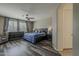 Spacious bedroom featuring wood floors, natural light, and stylish furnishings at 1197 W Fir Tree Rd, Queen Creek, AZ 85140