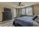 Bedroom featuring wood floors, natural light, ceiling fan and a television at 1197 W Fir Tree Rd, Queen Creek, AZ 85140