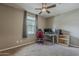 Bedroom featuring carpet, ceiling fan, window with shades, desk, and a gaming chair at 1197 W Fir Tree Rd, Queen Creek, AZ 85140