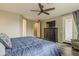 Bedroom featuring wood floors, natural light, ceiling fan and a television at 1197 W Fir Tree Rd, Queen Creek, AZ 85140