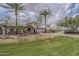 Beautifully landscaped community center with lush green grass and mature palm trees at 1197 W Fir Tree Rd, Queen Creek, AZ 85140