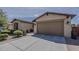Charming single-Gathering home showcasing a well-maintained two-car garage and desert landscaping at 1197 W Fir Tree Rd, Queen Creek, AZ 85140