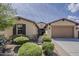 Inviting home exterior featuring manicured landscaping, a brick walkway, and a two-car garage at 1197 W Fir Tree Rd, Queen Creek, AZ 85140