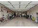 Spacious two-car garage with ample storage, workshop area, and overhead lighting at 1197 W Fir Tree Rd, Queen Creek, AZ 85140