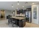 Modern kitchen showcasing dark cabinetry, stainless steel appliances, and a spacious granite island at 1197 W Fir Tree Rd, Queen Creek, AZ 85140