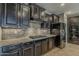 Modern kitchen features dark cabinetry, stainless steel appliances, and granite countertops at 1197 W Fir Tree Rd, Queen Creek, AZ 85140