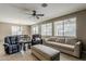 Spacious living area boasts neutral walls, ceiling fan, and tile flooring with a view of dining area at 1197 W Fir Tree Rd, Queen Creek, AZ 85140