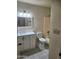 Clean and updated bathroom featuring a modern vanity and shower-tub combo at 124 S Cottonwood St, Chandler, AZ 85225