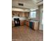Well-lit kitchen featuring ceramic tile flooring, light wood cabinetry, and modern appliances at 124 S Cottonwood St, Chandler, AZ 85225