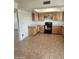 Spacious kitchen with light wood cabinets, white countertops, and black appliances at 124 S Cottonwood St, Chandler, AZ 85225