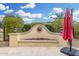 Landscaped seating area with rock detail, plants, and umbrella at 13051 W Black Hill Rd, Peoria, AZ 85383
