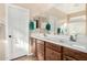 Bathroom featuring double sinks, a large mirror, and fresh towels for added convenience and comfort at 13051 W Black Hill Rd, Peoria, AZ 85383