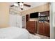 Bedroom features a closet, media center, and a view into another room at 13051 W Black Hill Rd, Peoria, AZ 85383