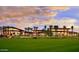 Expansive clubhouse with floor-to-ceiling windows offering beautiful golf course views at sunset at 13051 W Black Hill Rd, Peoria, AZ 85383