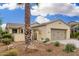 Attractive beige single-story home with desert landscaping, including a decorative palm tree and a two-car garage at 13051 W Black Hill Rd, Peoria, AZ 85383