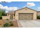 Charming beige single-story home with a two-car garage and beautiful desert landscaping at 13051 W Black Hill Rd, Peoria, AZ 85383