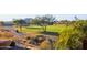 Scenic golf course view with lush fairways, mature trees, and a golfer on the green at 13051 W Black Hill Rd, Peoria, AZ 85383