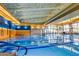 Bright indoor swimming pool with large windows, perfect for year-round exercise and recreation at 13051 W Black Hill Rd, Peoria, AZ 85383