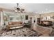 Spacious living room with dining area, featuring a ceiling fan, plush seating, and ample natural light, perfect for gatherings at 13051 W Black Hill Rd, Peoria, AZ 85383