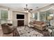 Bright living room features a ceiling fan, TV, comfortable seating, and large windows, creating a welcoming atmosphere at 13051 W Black Hill Rd, Peoria, AZ 85383