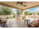 Spacious covered patio with built-in grill, bar seating and ceiling fans at 13051 W Black Hill Rd, Peoria, AZ 85383