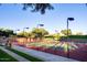 Well-maintained tennis court surrounded by lush landscaping, offering a serene and active lifestyle at 13051 W Black Hill Rd, Peoria, AZ 85383