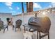Backyard barbecue area with a grill, seating, and lush landscaping for relaxing outdoors at 1307 E Encanto St, Mesa, AZ 85203
