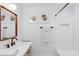 Modern bathroom featuring a vanity with decorative mirror and a tiled shower at 1307 E Encanto St, Mesa, AZ 85203