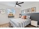 Bright bedroom featuring queen bed, nightstands, and sunny window view at 1307 E Encanto St, Mesa, AZ 85203