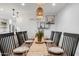 Bright dining area with a wood table set for a meal, lit by modern pendant lighting at 1307 E Encanto St, Mesa, AZ 85203
