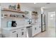 Well-lit kitchen features white subway tile backsplash and open wood shelving at 1307 E Encanto St, Mesa, AZ 85203