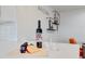 Close up on kitchen counter featuring wine, cheese, two glasses, and modern decor at 1307 E Encanto St, Mesa, AZ 85203