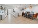 Modern open concept shows kitchen and dining space with sleek white cabinets and an island at 1307 E Encanto St, Mesa, AZ 85203