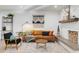 Inviting living room with a charming brick fireplace, plush seating, and decorative rug at 1307 E Encanto St, Mesa, AZ 85203