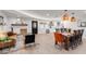 Open-concept living room and dining area boasts a cozy fireplace and stylish furnishings at 1307 E Encanto St, Mesa, AZ 85203