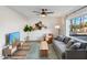 Bright living room with modern gray sofa, wood accents, and large windows at 1307 E Encanto St, Mesa, AZ 85203