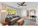 Cozy living room with gray couch, wood coffee table, and view of front yard at 1307 E Encanto St, Mesa, AZ 85203