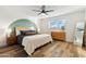 Bright main bedroom with a wood-frame bed, stylish decor, and lots of natural light at 1307 E Encanto St, Mesa, AZ 85203
