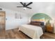 Bright main bedroom featuring a wood-frame bed and modern accent wall at 1307 E Encanto St, Mesa, AZ 85203