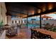 Covered patio with outdoor dining and seating, overlooking the pool and beautifully landscaped yard at 1307 E Encanto St, Mesa, AZ 85203