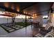 Relaxing covered patio with comfortable seating, outdoor lighting, and a view of the landscaped backyard at 1307 E Encanto St, Mesa, AZ 85203