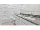 Bright bathroom with granite countertops, dual sinks, white cabinetry, and tub with shower at 1331 W Hess Ave, Coolidge, AZ 85128