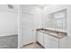 Bright bathroom featuring double sinks with granite countertops, white cabinets, and ample counter space at 1331 W Hess Ave, Coolidge, AZ 85128
