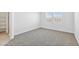 Cozy bedroom featuring a large window with blinds and new carpet at 1331 W Hess Ave, Coolidge, AZ 85128