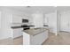 Contemporary kitchen features a large island with a sink, granite countertops, and stainless steel appliances at 1331 W Hess Ave, Coolidge, AZ 85128