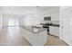 Bright kitchen features white cabinets, a gray granite island, stainless steel appliances, and seamless access to the dining area at 1331 W Hess Ave, Coolidge, AZ 85128
