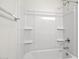 Bright bathroom showcasing a clean, modern bathtub and shower combo with built-in shelving at 1343 W Hess Ave, Coolidge, AZ 85128
